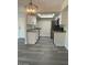 Modern kitchen with white cabinets, gray flooring, and stainless steel appliances at 6480 N 82Nd St # 2203, Scottsdale, AZ 85250