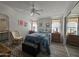 Spacious bedroom with ceiling fan, large windows and wood dresser at 650 N Hawes Rd # 4634, Mesa, AZ 85207