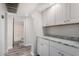 Laundry area with white cabinets and granite countertops at 7402 E Carefree Dr # 319, Carefree, AZ 85377