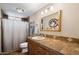 Well-lit bathroom with shower/tub combo and wood cabinets at 8106 N 11Th St, Phoenix, AZ 85020