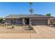 Single-story home with gray exterior, landscaped yard, and a two-car garage at 8619 E Via De Sereno --, Scottsdale, AZ 85258