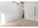 Bedroom with ceiling fan, neutral carpeting, and double door closet at 9263 E Karen Dr, Scottsdale, AZ 85260