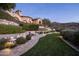 Landscaped backyard with a firepit and putting green at 11068 E Canyon Cross Way, Scottsdale, AZ 85255