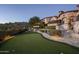 Landscaped backyard with putting green, stone pathways, and lighting at 11068 E Canyon Cross Way, Scottsdale, AZ 85255