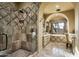 Spa-like bathroom with a large shower, soaking tub, and stone tile at 11068 E Canyon Cross Way, Scottsdale, AZ 85255