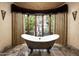 Spa-like bathroom with freestanding tub and garden views at 11068 E Canyon Cross Way, Scottsdale, AZ 85255