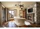Spacious bedroom with a stone fireplace and hardwood floors at 11068 E Canyon Cross Way, Scottsdale, AZ 85255