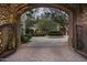 Ornate iron gates open to a private courtyard at 11068 E Canyon Cross Way, Scottsdale, AZ 85255
