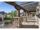 Stone covered patio with pergola and mountain views at 11068 E Canyon Cross Way, Scottsdale, AZ 85255
