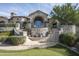 Stone exterior luxury home with a fountain and manicured landscaping at 11068 E Canyon Cross Way, Scottsdale, AZ 85255