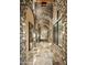 Stone hallway with arched entryways and large mirrors at 11068 E Canyon Cross Way, Scottsdale, AZ 85255
