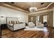 Serene main bedroom with upholstered bed and hardwood floors at 11068 E Canyon Cross Way, Scottsdale, AZ 85255