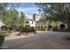 Large motor court with stone building and landscaping at 11068 E Canyon Cross Way, Scottsdale, AZ 85255