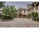 Elegant motor court with stone building and landscaping at 11068 E Canyon Cross Way, Scottsdale, AZ 85255