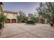 Brick motor court with double garage and landscaping at 11068 E Canyon Cross Way, Scottsdale, AZ 85255