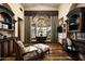 Home office with built-in bookshelves and hardwood floors at 11068 E Canyon Cross Way, Scottsdale, AZ 85255