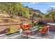 Spacious backyard patio with fire pit, seating area, and mountain views at 11132 E Juan Tabo Rd, Scottsdale, AZ 85255