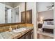 Bathroom with single vanity, view of bedroom, and neutral tones at 11132 E Juan Tabo Rd, Scottsdale, AZ 85255
