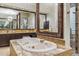 Spa-like bathroom with large soaking tub, double vanity, and walk in shower at 11132 E Juan Tabo Rd, Scottsdale, AZ 85255