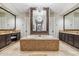 Large bathroom with soaking tub, dual vanities, and a large mirror at 11132 E Juan Tabo Rd, Scottsdale, AZ 85255