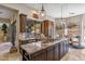 Open kitchen with large island, granite counters, and breakfast nook at 11132 E Juan Tabo Rd, Scottsdale, AZ 85255