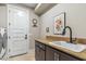 Bright laundry room with washer, dryer, and utility sink at 11132 E Juan Tabo Rd, Scottsdale, AZ 85255
