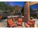 Covered outdoor kitchen with seating and grill at 11132 E Juan Tabo Rd, Scottsdale, AZ 85255