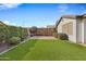 Artificial turf backyard with patio and string lights at 20865 E Timberline Rd, Queen Creek, AZ 85142