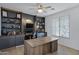 Modern home office with built-in shelves and a large desk at 20865 E Timberline Rd, Queen Creek, AZ 85142