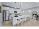 Modern kitchen with white cabinets, island with seating, and stainless steel appliances at 20865 E Timberline Rd, Queen Creek, AZ 85142