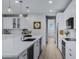 Open concept kitchen with island, stainless steel appliances, and white cabinets at 20865 E Timberline Rd, Queen Creek, AZ 85142