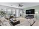 Living room with large windows, comfortable seating, and fireplace at 20865 E Timberline Rd, Queen Creek, AZ 85142