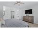 Main bedroom with large TV, dresser, and access to bathroom at 20865 E Timberline Rd, Queen Creek, AZ 85142