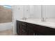 Modern bathroom with double vanity, shower, and bathtub at 21576 E Pecan Ct, Queen Creek, AZ 85142