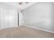 Spacious bedroom with double door closet and ceiling fan at 21576 E Pecan Ct, Queen Creek, AZ 85142