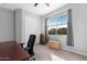 Bright bedroom with large window and built-in shelving at 21576 E Pecan Ct, Queen Creek, AZ 85142