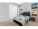 Bright bedroom with a queen bed, window, and closet at 21576 E Pecan Ct, Queen Creek, AZ 85142