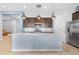 Modern kitchen with stainless steel appliances and a large island at 21576 E Pecan Ct, Queen Creek, AZ 85142