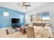 Spacious living room with a ceiling fan and large windows at 21576 E Pecan Ct, Queen Creek, AZ 85142