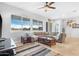 Bright living room with comfy sectional sofa, coffee table, and large windows at 21576 E Pecan Ct, Queen Creek, AZ 85142