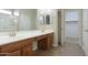 Double vanity bathroom with wood cabinets and large mirror at 3214 N Desert Horizons Ln, Casa Grande, AZ 85122