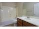 Clean bathroom with a tub, toilet, and vanity with wood cabinets at 3214 N Desert Horizons Ln, Casa Grande, AZ 85122
