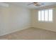 Bright bedroom with ceiling fan and large window at 3214 N Desert Horizons Ln, Casa Grande, AZ 85122