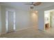 Bedroom with door to bathroom and ceiling fan at 3214 N Desert Horizons Ln, Casa Grande, AZ 85122