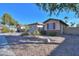 Landscaped front yard with gravel, desert plants, and a two-car garage at 3214 N Desert Horizons Ln, Casa Grande, AZ 85122
