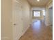 Bright hallway with tile floors and doors leading to other rooms at 3214 N Desert Horizons Ln, Casa Grande, AZ 85122
