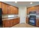 View of kitchen with wood cabinets and granite countertops at 3214 N Desert Horizons Ln, Casa Grande, AZ 85122