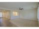 Spacious living room with neutral carpeting and ceiling fan at 3214 N Desert Horizons Ln, Casa Grande, AZ 85122
