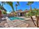 Inviting backyard pool with a flagstone patio and palm trees at 3214 N Desert Horizons Ln, Casa Grande, AZ 85122