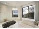 Spa-like bathroom with walk-in shower, soaking tub, and mountain views at 5630 E Rockridge Rd, Phoenix, AZ 85018
